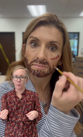 Person painting a beard on the face using pediatric skin care approved paints.