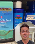 alec speaks in front of a grocery store shelf of acne fighting creams